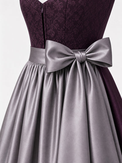 Dirndl Rica in Aubergine mit Perlgrau Schürze - Detailansicht Taille und Schleife